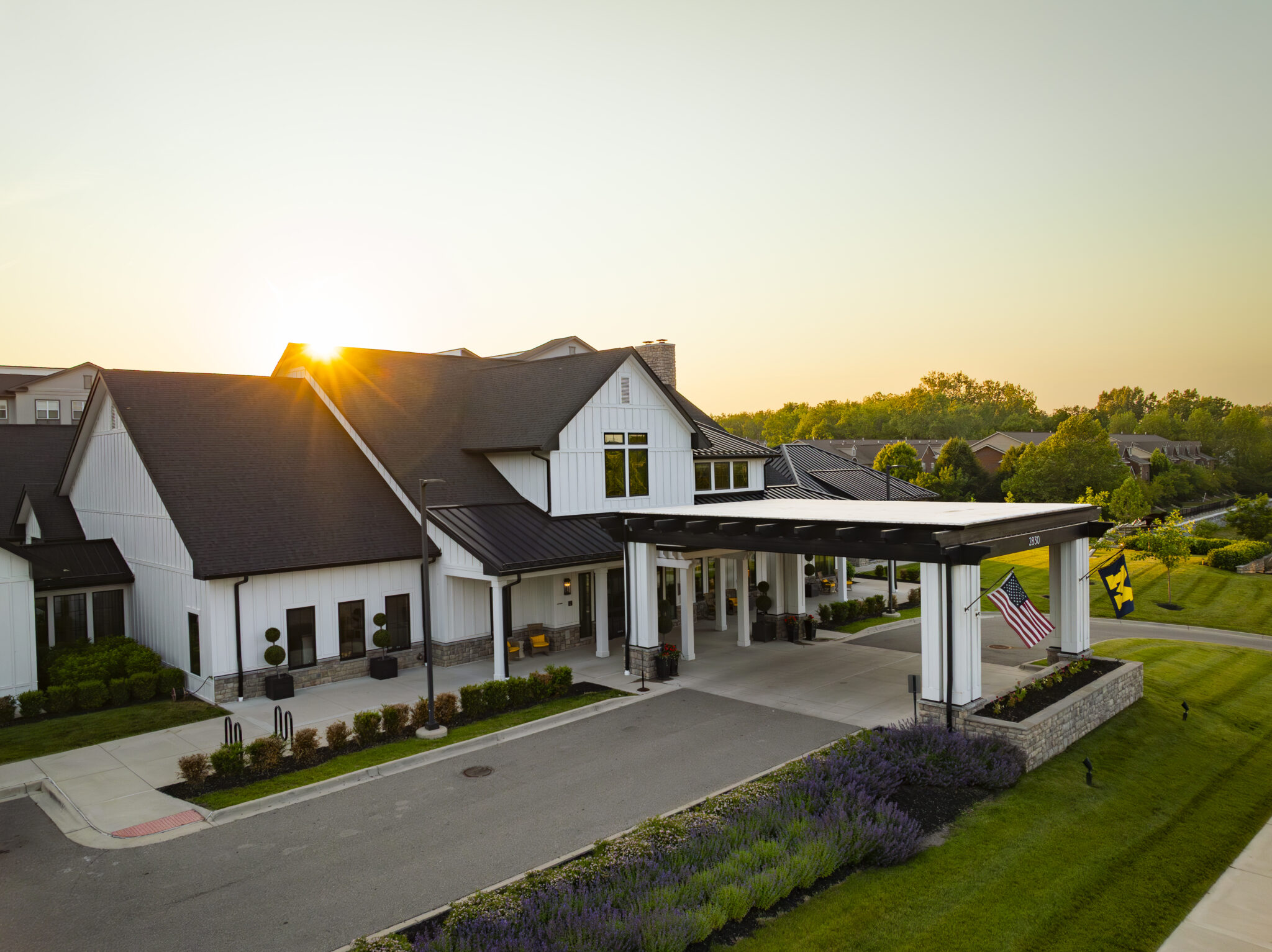 A resident enjoying fruit in the dining room of A formal dinner plate of scallops and greens in the dining room of Clarendale Ann Arbor, a senior living community with care services in Ann Arbor, Michigan.